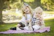 Sweet Little Girl Hugs Her Baby Brother at the Park