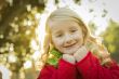 Little Girl Wearing Winter Coat and Scarf at the Park