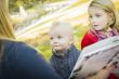 Mother Reading a Book to Her Two Adorable Blonde Children