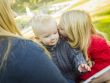 Mother Reading a Book to Her Two Adorable Blonde Children