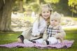 Sweet Little Girl with Her Baby Brother at the Park