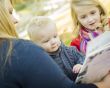 Mother Reading a Book to Her Two Adorable Blonde Children