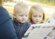 Mother Reading a Book to Her Two Adorable Blonde Children