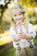Cute Little Girl Holding Christmas Candy Canes Outdoors