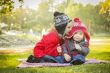 Little Girl Whispers A Secret to Baby Brother Outdoors