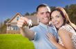 Military Couple with House Keys In Front of New Home