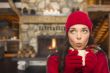 Mixed Race Girl Enjoying Warm Fireplace and Holding Mug