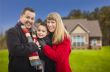 Happy Mixed Race Family in Front of House