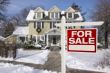 Home For Sale Sign in Front of Snowy New House