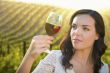 Young Adult Woman Enjoying A Glass of Wine in Vineyard