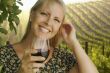 Attractive Woman Enjoying a Glass of Wine at the Vineyard