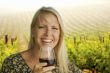 Attractive Woman Enjoying a Glass of Wine at the Vineyard