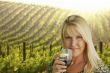 Attractive Woman Enjoying a Glass of Wine at the Vineyard