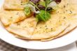 garlic pita bread pizza with salad on top