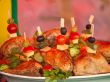 Fried chicken legs on a plate decorated with vegetables and herb