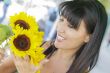 Pretty Italian Woman Looking at Sunflowers at Market