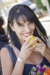 Pretty Italian Woman Smelling Oranges at the Street Market