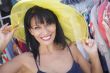 Pretty Italian Woman Trying on Yellow Hat at Market