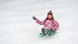 girl sliding on sled 