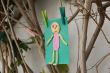 Child`s handmade small man on a green color paper 