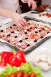 Men cooking fresh italian pizza close up