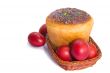 Red Easter eggs and Easter bread in a basket on a white backgrou