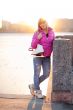 Blond woman standing with ice skates