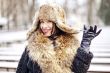 Joyfull russian woman in fur hat and coat