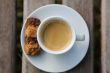 A cup of Italian espresso with a biscuit