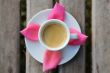 Cup of coffee on the wooden surface - top view