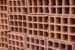 A row of hollow clay bricks - background