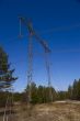 High voltage power lines against the blue sky and the spring for