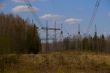 High voltage power lines against the blue sky and the spring for