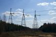 High voltage power lines against the blue sky and the spring for