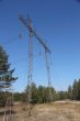 High voltage power lines against the blue sky and the spring for