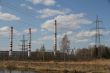 Factory pipes and high voltage power lines against the blue sky 