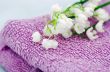 Spa setting of  towels, soap and lilies of the valley 