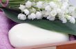 Spa setting of towels, soap and lilies of the valley 