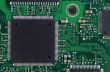 Green computer board with chips and components. 