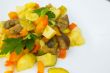 Stewed vegetables with curcuma on the white plate