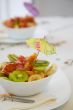 A white plate of fruit salad