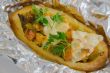 Baked jacket potato with vegetables,chicken filet,fresh parsley 