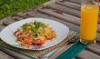 Pasta with vegetables and a glass of fresh orange juice