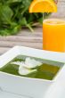 Spinach cream soup and a glass of fresh orange juice