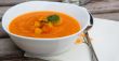 A plate of carrot soup with fresh pasley