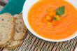 A plate of carrot soup with fresh pasley