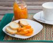 Homemade tangerine marmalade on the small square dessert plate