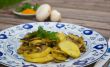 Baked potatoes with mushrooms and parsley on the white blue plat