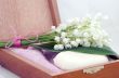Spa setting of towels, soap and lilies of the valley 