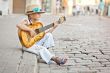 Girl playing guitar on the street